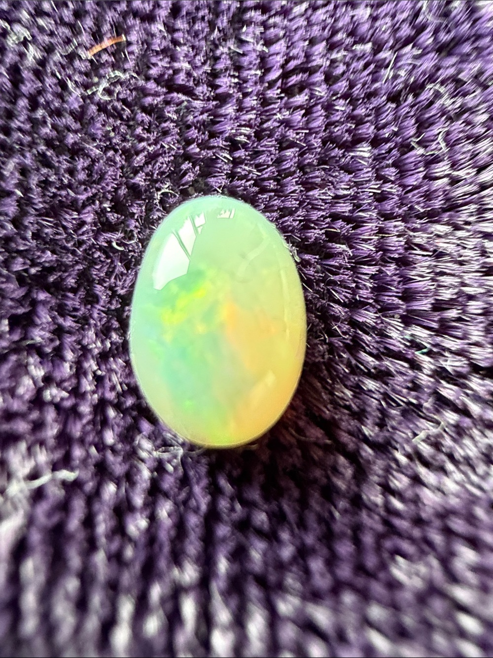 Natural opal cabochon gemstone, red blue green fire splashes, 7x5 mm